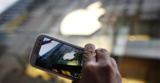 Passerby photographs Apple store logo with his Samsung Galaxy phone in central Sydney